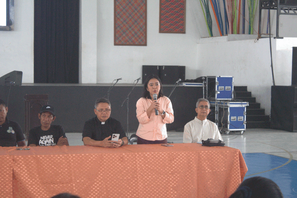 Fe speaking at a community forum