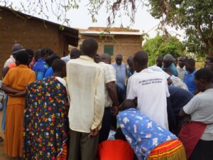 Community members select a small team of representatives to draw on the maps, then huddle around to observe and comment