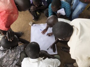 Community members draw sketch maps on paper to document their existing perceptions of their community land