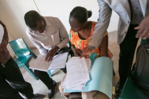 Tchiamala and Faith analyzing case management forms at the Ntsu community advice office