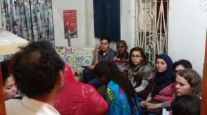 Participants listening to a presentation by Khalid Hussain about the paralegal work of Namati's Citizenship program in Dhaka, including Sharif, Jovin, Samaa, Wigayi, Yasmine, Nidal and Sawsan.