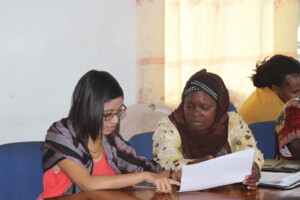 Khin Htet Wai & Bindu Fofana discussing case forms.