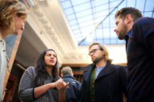 Faculty Purvi Shah speaks with Will Bennett and Dan Kass between sessions.