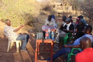 Team Isiolo listening to the Dr. Hussein, Director of their local host organization, Kivulini Trust.