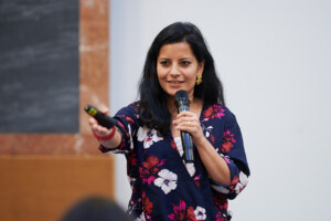 Sukti Dhital from the Robert L. Bernstein Institute for Human Rights at NYU School of Law gives the microphone to a participant